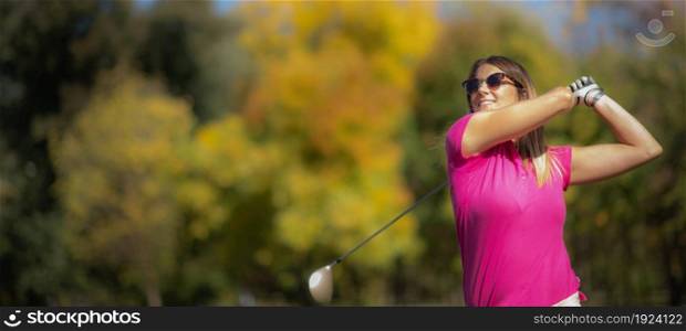 Lady golfer in a golf swing position