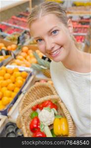 Lady holding basket of fruit & veg