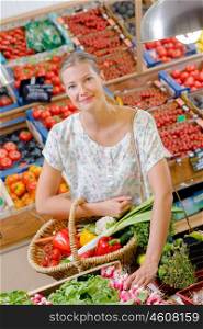 Lady holding basket of fruit & veg, choosing radishes