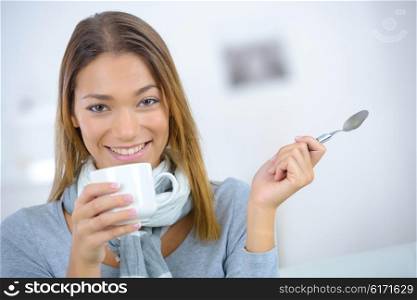 Lady holding cup and spoon