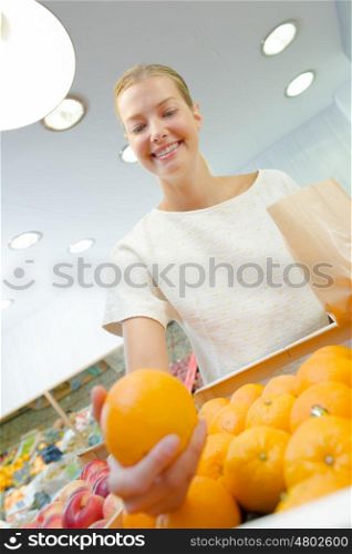 Lady holding orange in outstretched arm