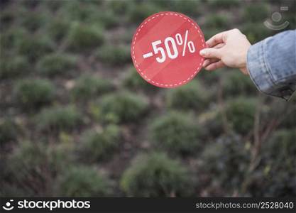 lady holding red sale sign