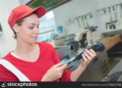 Lady in fast food outlet taking card payment