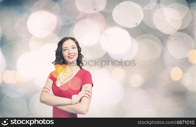 Lady in red. Young woman in red dress against bokeh background