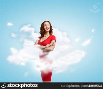Lady in red. Young woman in red dress and white feathers flying in air