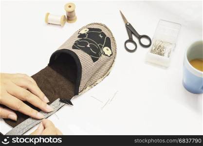 Lady is making handmade cloth soft shoe