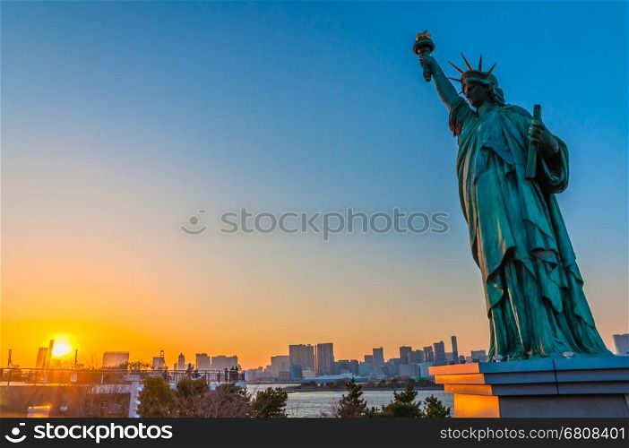 Lady liberty juxtaposed stand near Rainbow Bridge in Odaiba