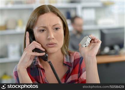 Lady on telephone, looking worried
