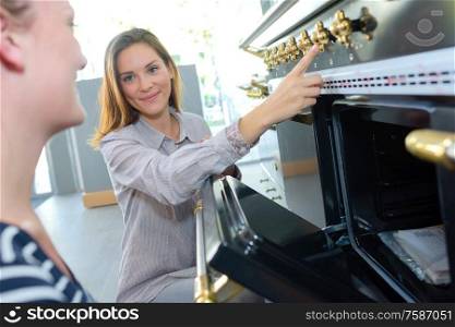 Lady pointing to controls on range cooker