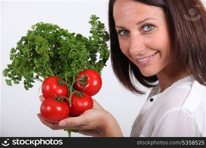 lady posing with tomatoes