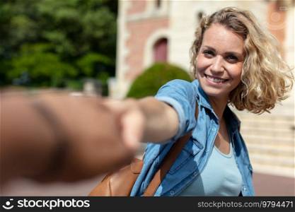 lady pulling friend to visit architectural building