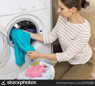 lady putting laundry washing machine