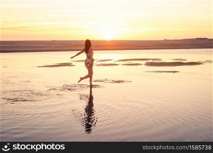 Lady running on water into the sunset