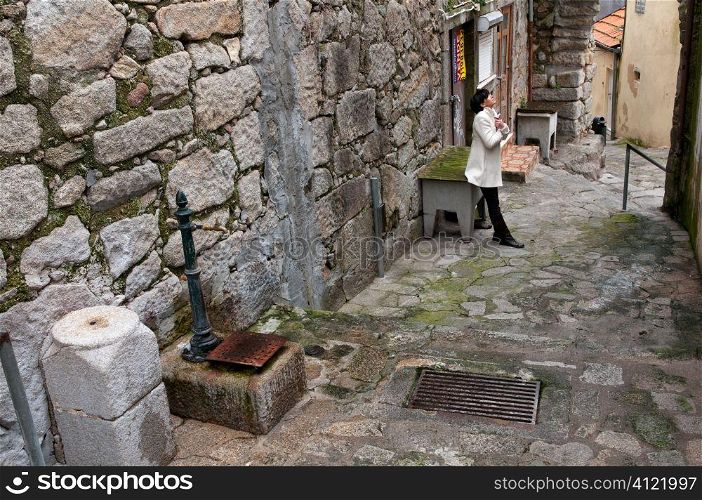 Lady standing in narrow street