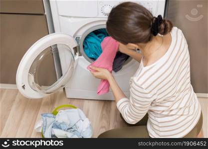 lady taking clothes out washing machine. High resolution photo. lady taking clothes out washing machine. High quality photo