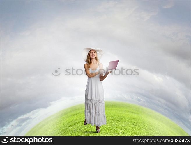 Lady using laptop. Young lady outdoor with laptop in hands