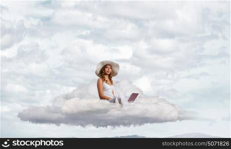 Lady using laptop. Young lady sitting on cloud with laptop on knees