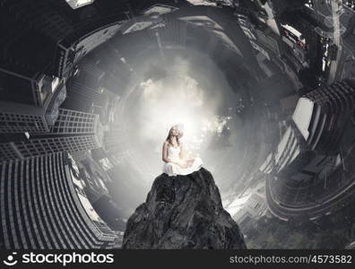 Lady using laptop. Young lady sitting on top of mountain with laptop