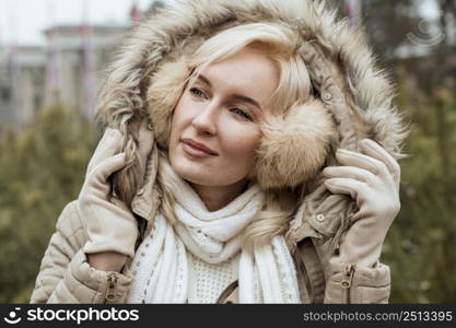 lady winter wearing ear muffs jacket with hood