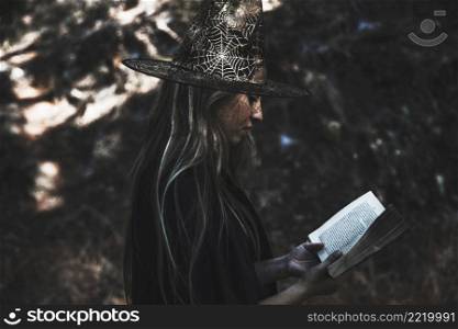 lady witch costume reading book