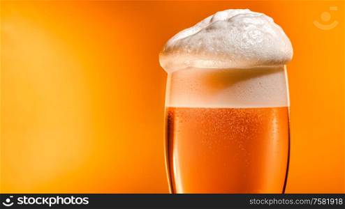 Lager beer settles in the glass with a white cap of foam