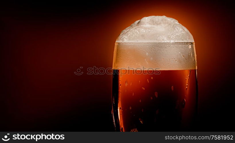 Lager beer settles in the glass with a white cap of foam