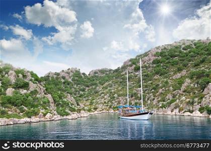 lagoon, sailing ship and mountainous coast