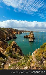 Lagos town summer coastline (Ponta da Piedade, Algarve, Portugal). All people are unrecognizable.