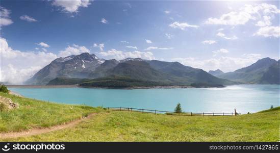 Lake and meadow by the mountains in the French Alps.