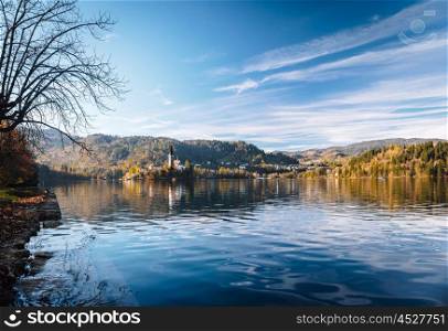 Lake Bled in the Alpine mountains in autumn under blue sky