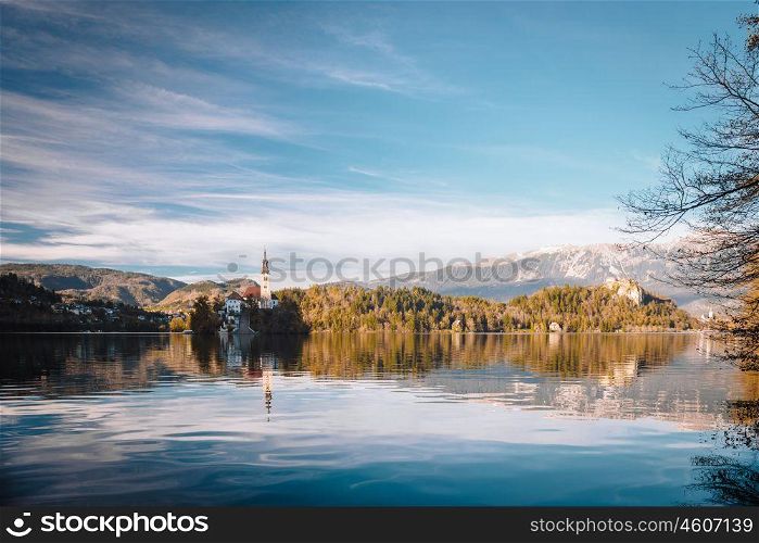 Lake Bled in the Alpine mountains in autumn under blue sky