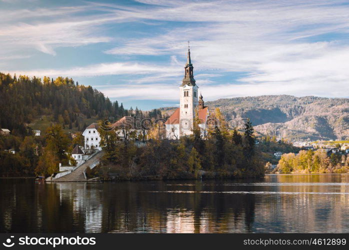 Lake Bled in the Alpine mountains in autumn under blue sky