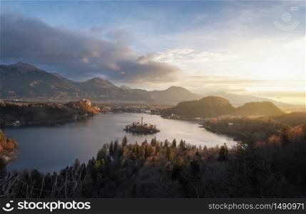 Lake bled landscape surrounded by mountains, at sunrise, in Slovenia. Famous travel location. Idyllic scenery of Bled island. Julian Alps mountains.