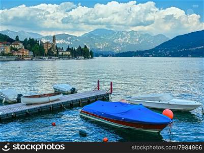 Lake Como (Italy) shore summer view with boats in front.
