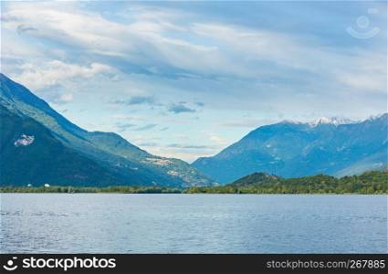 Lake Como (Italy) summer cloudy view with snow on mount top .