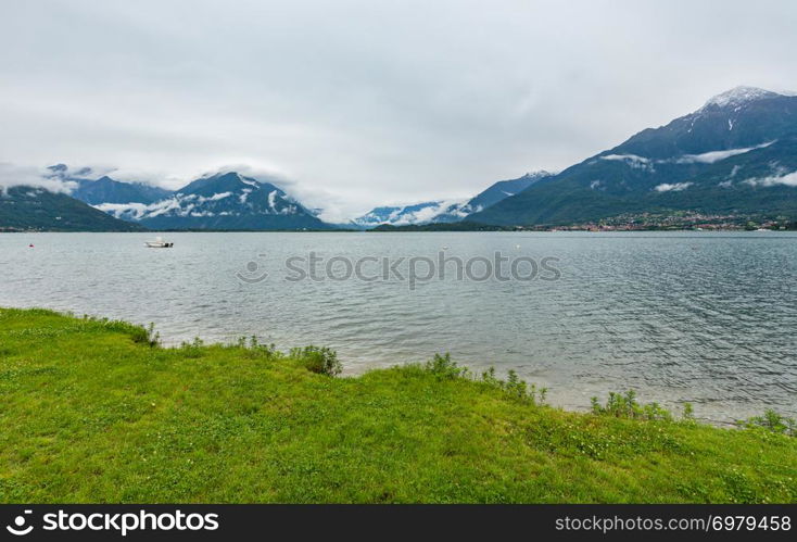 Lake Como (Italy) summer cloudy view with snow on mount top .