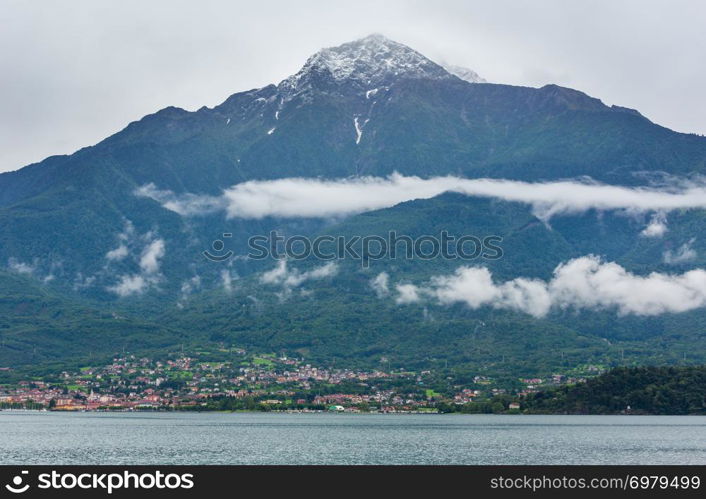 Lake Como (Italy) summer cloudy view with snow on mount top .