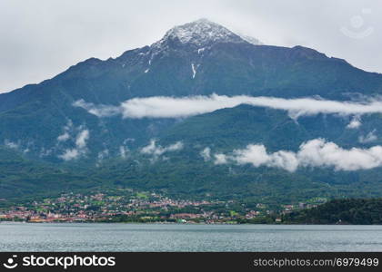 Lake Como (Italy) summer cloudy view with snow on mount top .