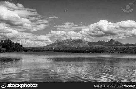 lake in black and white with reflections of clouds on water
