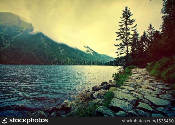 Lake in mountains. Fantasy and colorfull nature landscape. Retro vintage picture.
