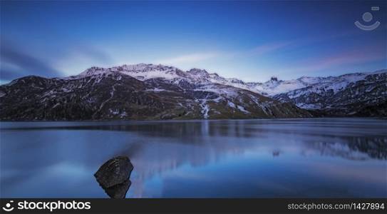 Lake in the French Alps. reflection of the snowy mountains in autumn