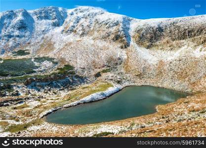 Lake in the mountains- landscape with snow and sunset time