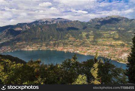 Lake Iseo with settlements on the shore and a mountain range around. Lombardy. Italy