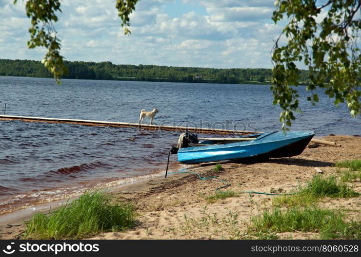 Lake Kenozero . Motor boat on the shore. Arkhangelsk region, Russia