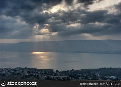 Lake Kinneret in the morning, sun rays are shining through the clouds