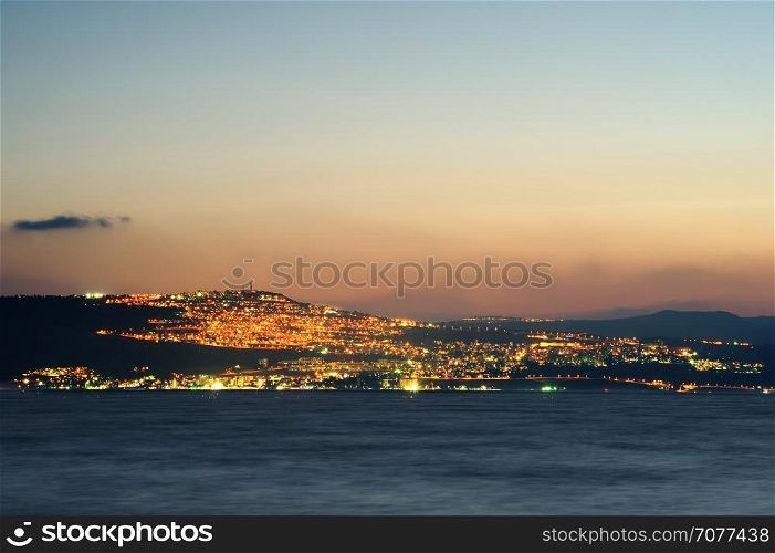 Lake Kinneret on the Sunset and the lights of Tiberias. Sea of Galilee (Kinneret), the largest freshwater lake in Israel