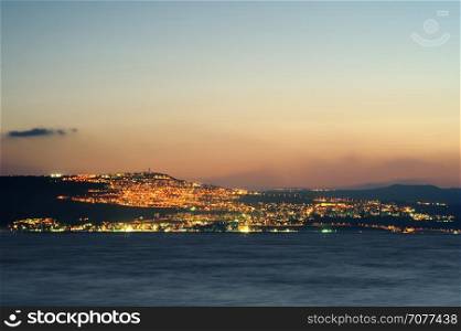 Lake Kinneret on the Sunset and the lights of Tiberias. Sea of Galilee (Kinneret), the largest freshwater lake in Israel