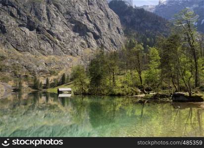 Lake Obersee in the Berchtesgaden Alps. The Fischunkelalm can be seen on the other side of the lake.. Lake Obersee near Berchtesgaden