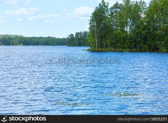 Lake Rutajarvi summer view with forest on the edge and water lily on surface (Urjala, Finland).
