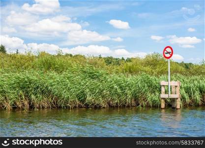 Lake scenery with a red no boating sign